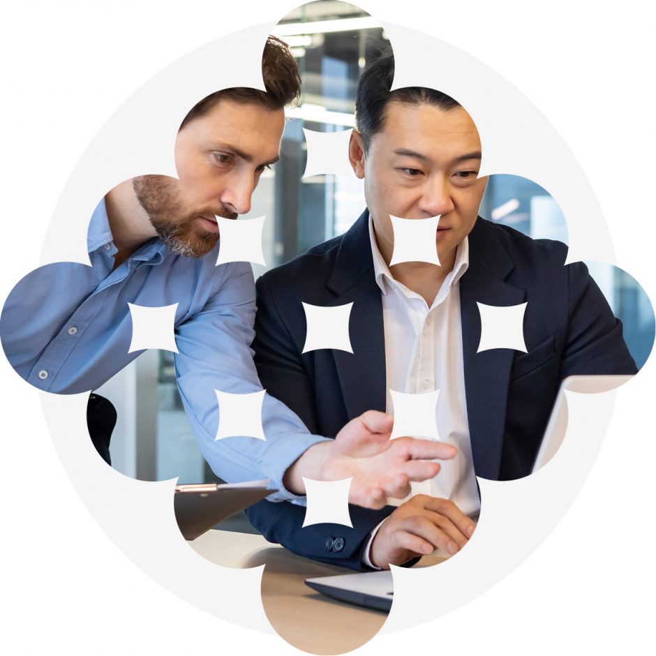 Two men working at a laptop